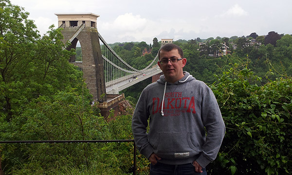 Chris Burn standing in front of Clifton Suspension Bridge